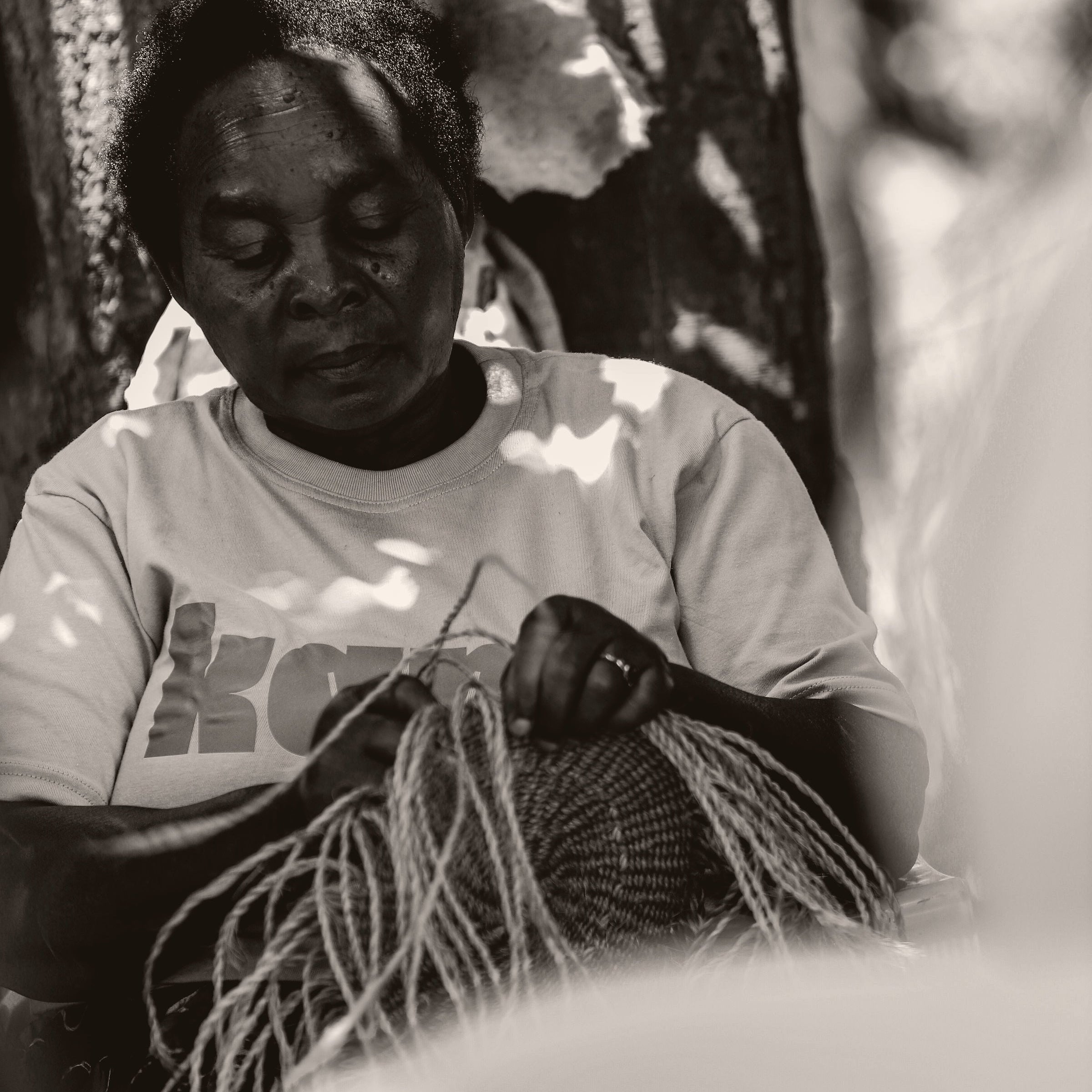 Person working with fibers in a natural setting